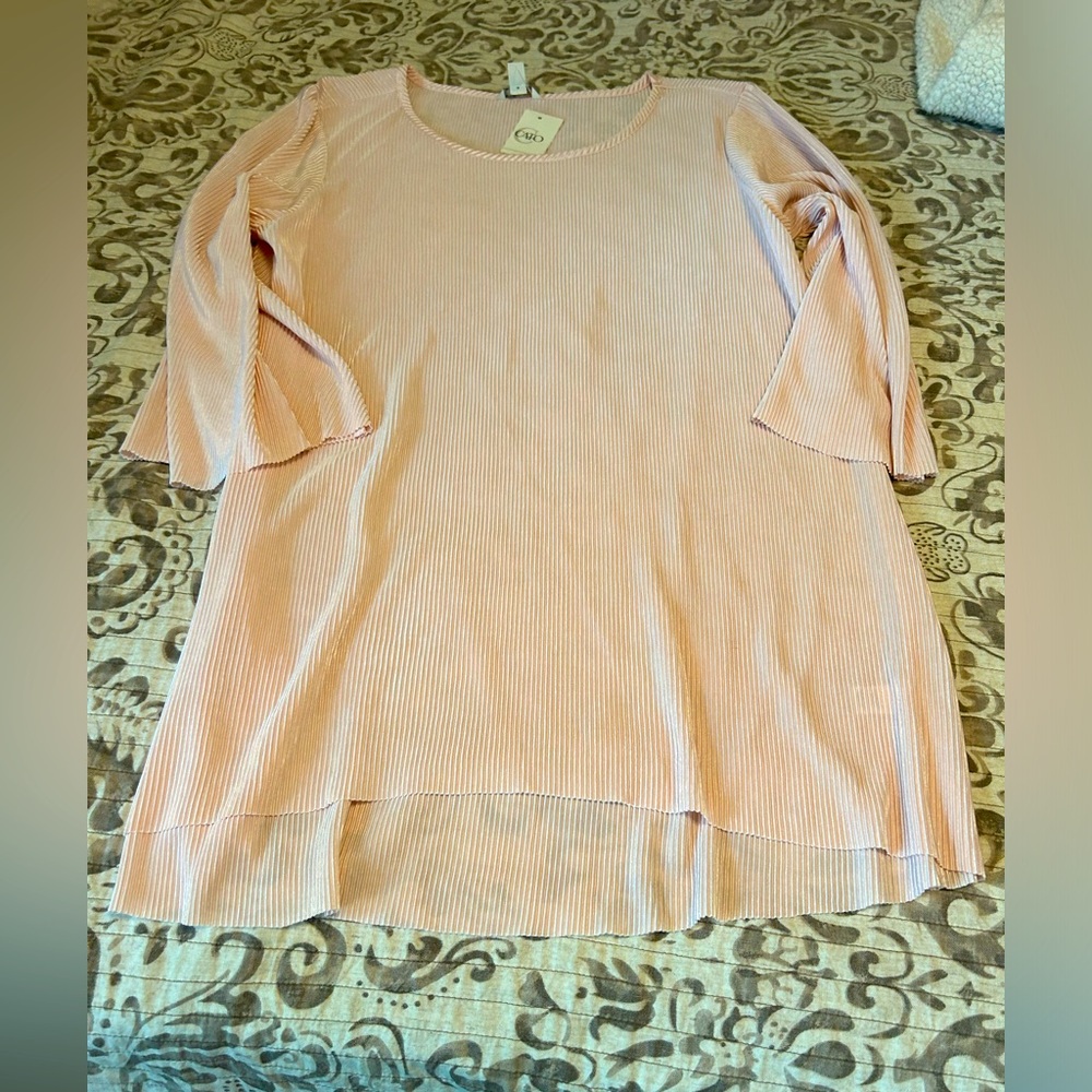 Peach flowy tunic small pleats to cover any unwanted curves.